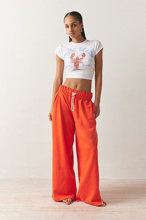 Out From Under sweatpant made special with piping details. Designed in a relaxed wide-leg silhouette featuring a ruffled elastic waistband with drawstring tie, side pockets and split hems. Exclusively at Urban Outfitters. Features Out From Under Hoxton piping wide leg sweatpant Wide leg sweatpant Soft and stretchy knit Ruffled elastic waistline with drawstring tie Side pockets with contrast piping down the sides Split hems Relaxed wide-leg fit Full length Easy pull-on style UO exclusive Content Sweatpants Aesthetic, Orange Sweatpants, Baggy Sweatpants, Green Fits, Contrast Piping, Feel Pretty, Sweat Pants, Fit Inspo, Christmas Wishlist