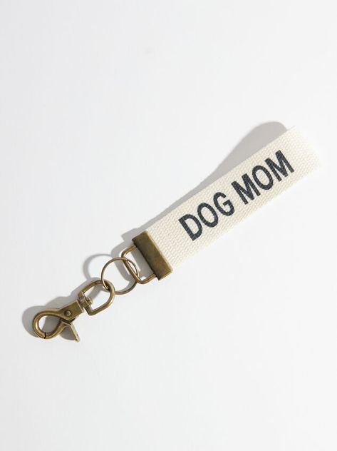 Use this dog mom keychain and wear it proudly! It’s a great way to keep all your keys/wristlet/etc. tethered in one place.  5” length Clasp closure Imported Dog Mom Jewelry, Dog Mom Merch, Dog Mom Crafts, Dog Mom Accessories, Dog Mom Gifts Ideas, Aesthetic Dog Stuff, Dog Mom Aesthetic, Canvas Keychain, Dog Mom Keychain