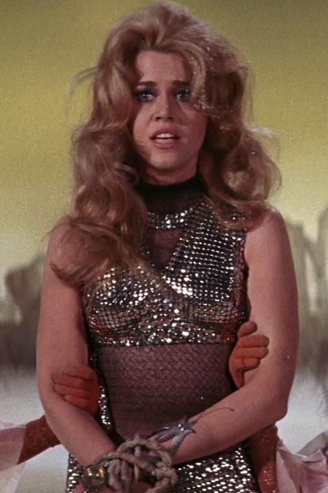 🚀✨ Dive into the cosmic allure of Barbarella! 🌌💋 From iconic comics to sizzling movies, she's the ultimate symbol of sci-fi sexiness. 🔥💄 Embodied by the stunning Jane Fonda, Barbarella blends fearless adventure with unmatched style. 🌟💥 Get lost in her universe of glamour, power, and irresistible charm! 💫💃 Ready to embrace your inner intergalactic goddess? 👑🌠 #Barbarella #CosmicQueen #SciFiGlam 👠🚀 Jane Fonda Barbarella, Futurism Fashion, Personality Quotes, Disco Glam, Rocky Horror Show, Cult Movie, Sci Fi Fashion, Scantily Clad, Character Profile