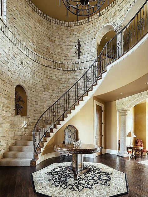 Make a grand entrance into the foyer with these curved castle-like stairs. Entrance With Stairs, Curved Entrance, Foyer With Curved Staircase, Mediterranean Staircase, Foyer With Stairs, Winding Staircase, Wwe Diva, Stair Case, Curved Staircase