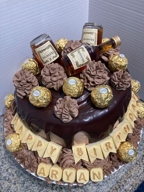 Hennessy themed birthday cake. Chocolate cake with chocolate ganache drip over chocolate frosting. White chocolate candy melts. Ferraro Rocher chocolates and mini Hennessy bottles. Ferraro Rocher Cake Birthday, Hennessy Birthday Cake, Chocolate Cake With Chocolate Ganache, Chocolate Ganache Drip, Hennessy Bottle, Ganache Drip, Cake With Chocolate Ganache, Rocher Chocolate, White Chocolate Candy