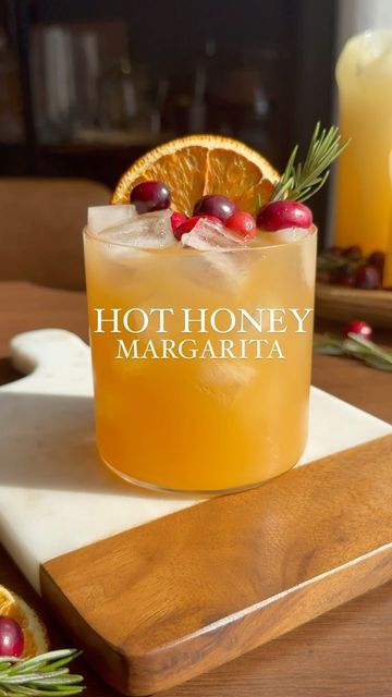 Nikki Sips 🤘🏻🍸 on Instagram: "Don’t forget about your tequila lovers as you prep for your holiday! This apple cider hot honey margarita is making me thankful for @mikeshothoney 🙌🏼. The perfect balance of spice & sweetness, you have to try it! Mike’s hot honey is available at Whole Foods, or my Amazon Storefront (link in bio 🫶🏼) _____ Hot Honey Margarita You’ll need: 3.5 oz apple cider 3/4 lime juice 1 oz Mike’s hot honey 1/2 oz orange liqueur 1.5 oz tequila Dried oranges wheel Few cranberries Sprig of rosemary Combine cider, honey, tequila, orange liqueur, and lime juice. Shake vigorously with ice. Strain into rocks glass with fresh ice, and garnish with cranberries, dried orange wheel, and a rosemary sprig. 🤗 #thanksgivingdrinks #mikeshothoney #margaritas #holidaymargarita #than Hot Honey Cranberry Margaritas, Hot Honey Margarita, Dried Orange Cocktail, Holiday Margaritas, Cocktail Recipes Tequila, Cranberry Margarita, Orange Wheels, Thanksgiving Drinks, Orange Cocktails