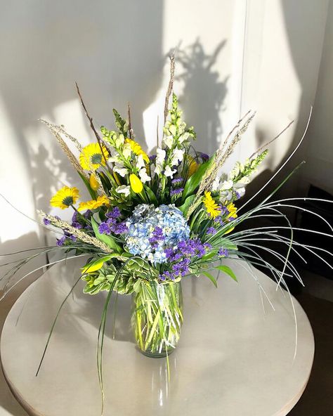 Sunshine and tranquility unite in this stunning yellow and blue floral arrangement! 💛💙 Perfect for adding a cheerful touch to any space. How would you style these blooms in your home? Share your ideas below! 🌿✨ #rozaflowers #floraldesign #yellowandblue #flowerarrangement #homedecor #flowerinspiration #torontoflorist Floral Arrangement, Blue Floral, Floral Arrangements, Florist, Flower Arrangements, Floral Design, Yellow, Flowers, Floral