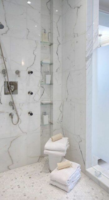 Picture of a refined modern bathroom with an oval black tub, a niche with printed tiles with shelves used for decor and storage, greenery in a jug Tile Shower With Niche, Niche With Shelves, Vertical Shower Niche, Shower With Niche, Marble Tile Shower, Christmas Color Schemes, Niche Shelves, Marble Shower Tile, Printed Tiles