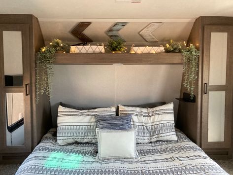 RV bedroom decor, fairy lights, plants in an RV, camper bedding, rv decor Travel Trailer Bedroom Decor, Camper Bedroom With Window Behind Bed, Small Camper Bedroom Remodel, Camper Bunkhouse Decor, Modern Camper Decor, Travel Trailer Master Bed Remodel, Rv Shelf Above Bed, Camper Bedroom Remodel Ideas, Tiny Camper Bathroom Ideas