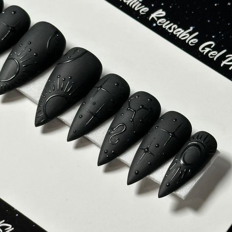 Welcome to LD Nails! 🖤 One set of 10 REUSABLE Press On Nails 🖤 🖤 Made to order in your shape & size 🖤 🖤 Black on Black: Zodiac. Velvet Matte black press on nails with glossy black zodiac detailing ♌️ ♊️ Leo & Gemini are pictured, Please leave a note with your sign in the personalization box, so I can customize it just for you! 🖤 Purchase INCLUDES an application kit! It consists of: 🖤 detailed application & removal instructions 🖤 a sealed and sanitary mani kit (100/180 file, buffer block, Matte Black Skeleton Nails, Punk Press On Nails, Shiny On Matte Nails, Black Nails Press On, Planchette Nail Art, Black Gold Manicure, Celestial Black Nails, Matte Black Witchy Nails, Zodiac Nails Designs Leo