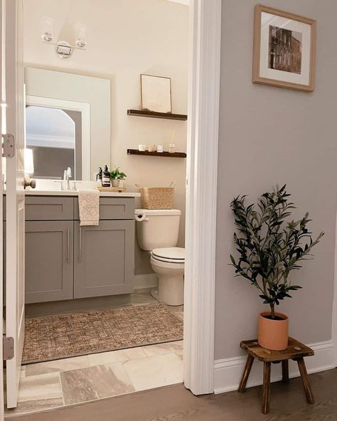 White Bathroom With a Grey Vanity and Neutral Décor - Soul & Lane Taupe Tile Bathroom, Grey And White Bathroom Ideas, Taupe Bathroom, White Bathroom Ideas, Grey And White Bathroom, Grey Vanity, White Vessel Sink, Wood Floor Bathroom, Gray Painted Walls