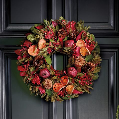 Add holiday cheer to your house with this festive wreath of dried botanicals, including preserved red and green salal leaves, cedar, pinecones, pepper berries, quince slices, and natural pomegranates. Twig base. 18" dia. English Christmas Traditions, Salal Leaves, Pepper Berries, Pomegranate Decor, Williamsburg Christmas, Dried Botanicals, Fruit Wreath, Silk Wreaths, Bazaar Crafts