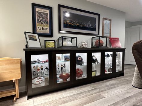 Sports Memorabilia Display Wall Man Cave, Sports Memorabilia Display Wall Shelves, Man Cave Memorabilia Display, Trophy Wall Display Ideas Office, Sports Memorabilia Office, Man Cave Jersey Display, Sports Display Wall, Displaying Sports Memorabilia, Sports Collectibles Display