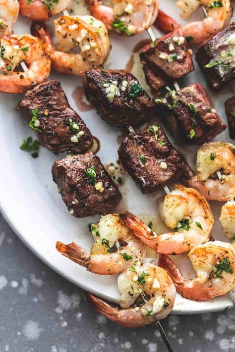 These Garlic Butter Surf and Turf Kabobs are everything you want in a kabob — beef and seafood, on the grill, with that lemony, garlicky, smoky taste you yearn for at the end of a long, hard weekend when you just want to sit back and enjoy a delicious meal with those you love. Surf And Turf Kabobs, Shrimp Kabob Recipes, Teriyaki Steak, Shrimp Kabobs, Steak And Shrimp, Kabob Recipes, Surf And Turf, Grilled Beef, Steak Bites