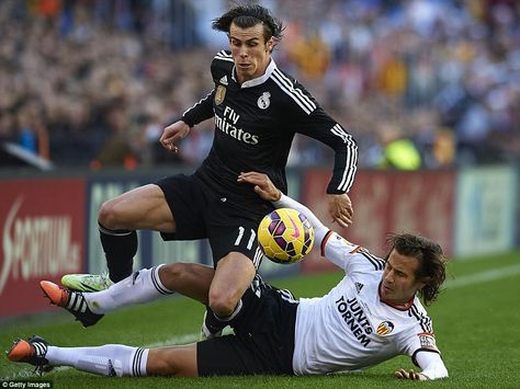 Real Madrid record signing Bale is tackled by Valencia's Lucas Orban to concede a first-half free kick. Cristiano Ronaldo Real Madrid, Valencia Cf, Gareth Bale, Free Kick, Valencia Spain, January 4, Winter Break, Cristiano Ronaldo, Real Madrid