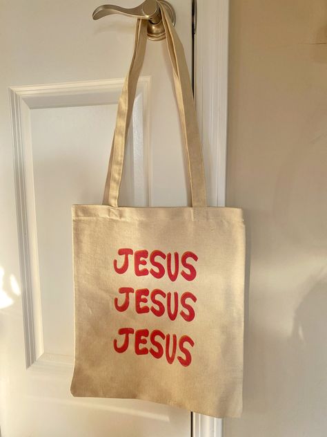 Jesus tote bag in pink and orange!!  Dimensions are 13x15 Christian Clothes Aesthetic, Tote Bag Inspo Painting, Jesus Basket, Christian Bags, Bible Study Tote Bag, Jesus Merch, Bible Study Crafts, Jesus Tote Bag, Bible Tote Bag