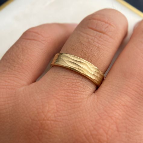 Details: 10k or 14k gold, sterling silver Horizontal wave finish 6mm wide, 1.2mm thick Polished edges and interior Gentle comfort fit interior edge Available in quarter sizes by request For platinum, or 18k gold or higher, karat please email us for a quote Style: Our Unique Gold Band Ring Inspired by Serene Beaches Imagine capturing the essence of summer and the tranquility of a beach within a ring – our Gold band ring does just that. Inspired by the gentle waves etched in the sand and the peace Thick Gold Band, Gold Wave Ring, Ring Inspired, Wave Ring, Montana Sapphire, Casting Jewelry, Gold Band Ring, Enamel Ring, Salt And Pepper Diamond