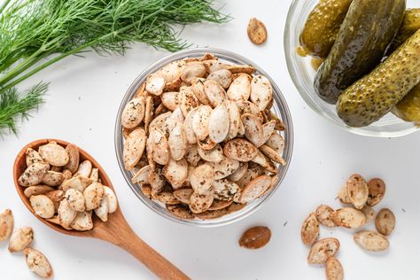 For a unique take on pumpkin seeds, make this dill pickle version. The seasonal snack recipe is flavored with white vinegar, dried dill, and garlic powder. Pumpkin Pickle Recipe, Ranch Pumpkin Seeds, Dill Pickle Pumpkin Seeds, Dill Pumpkin Seed Recipes, Dill Pickle Popcorn Seasoning, Dill Pickle Cashews, Pumpkin Seed Recipe, Savory Pumpkin Seeds, Flavored Pumpkin Seeds