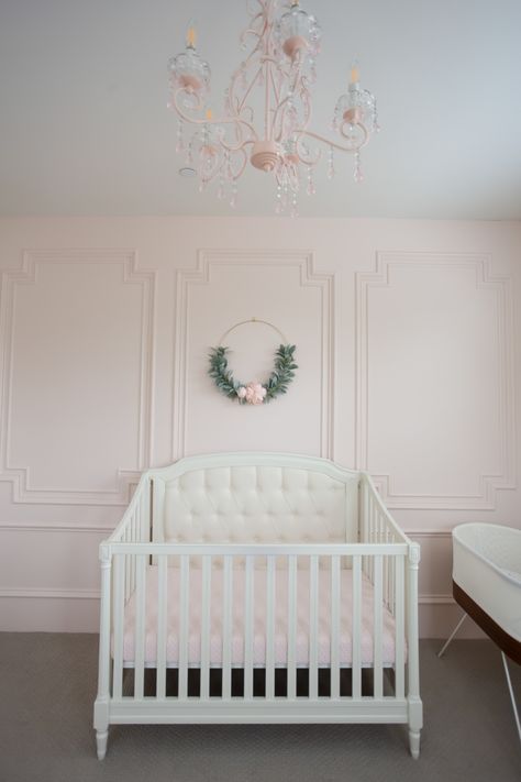 Intimate White (BM) pale blush pink painted accent wall with millwork in a beautiful nursery - StylishPetite. #intimatewhite #blushpink Painted Accent Wall, Intimate White, Blush Pink Paint, Pink Accent Walls, Best Bedroom Paint Colors, Origami White, Pink Paint Colors, Shoji White, Blue Dresser