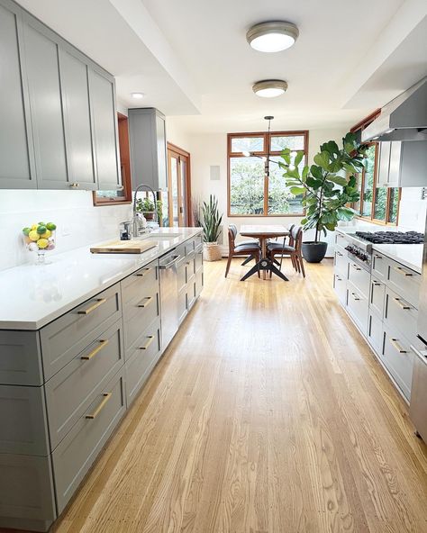 Benjamin Moore Arctic Shadows on wide galley kitchen cabinets with white walls Wide Galley Kitchen Layout With Island, Galley Kitchen White Shaker Cabinets, Benjamin Moore Arctic Shadows, Kitchen Cabinets With White Walls, Gally Kitchen Design Ideas, Galley Kitchen With Peninsula Layout, Double Gallery Kitchen Design, Large Galley Kitchen With Island, Wide Galley Kitchen Layout