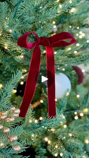 631 reactions · 61 shares | Create affordable and gorgeous velvet ribbon bows for your Christmas tree to add extra holiday magic. Comment BOW and I will message you the ribbon I used. 

I love that these bows can be made affordably and you can customize the color and size to fit your holiday aesthetic. I used a spool of burgundy velvet ribbon from Amazon and was able to make about 25 bows, each strand was about 30-36 inches in length. Add ornament hangers to the back of the bows and attach them to the tree. | Ashley Hoglan | Outfit Ideas & Lifestyle Bow Ideas For Christmas Tree, Velvet Bows On Christmas Tree Diy, Christmas Tree With Bows Ribbons, How To Tie A Velvet Ribbon Bow, Christmas Tree With Red Bows, Velvet Bows On Christmas Tree, Bows On Christmas Tree, Velvet Ribbon Christmas Tree, Christmas Tree With Bows