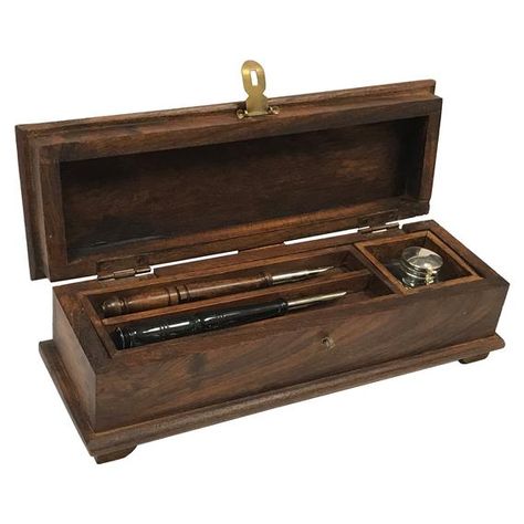 This distressed, portable antique reproduction Writing Pen Box is the same style used in colonial times and perfect storage for all your writing accessories and tools. Makes for an outstanding, unique gift item or perfect for period home decor.Set includes:- 1 clear, glass inkwell- 1 turned teak wood fountain pen- 1 turned ox horn fountain pen- 1 packet of black ink powder- Measures 12"L x 4"w x 3-3/4"h- Made of durable, beautiful teak and mango wood, and finished with beeswax- Hinged, bevel cut Wooden Hinges, Antique Hinges, Fancy Pens, Unique Gift Items, Writing Accessories, Wood Pens, Writing Pens, Pen Nib, Pen Gift