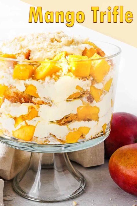 A mango trifle with angel food cake, white chocolate whipped cream, and macadamia nuts. #mango #trifle #mangotrifle #whitechocolate Mango Trifle Recipes, Mango Trifle, White Chocolate Whipped Cream, Cake White Chocolate, Christmas Trifle, Cheesecake Trifle, Mango Dessert Recipes, Mango Dessert, Trifle Dish