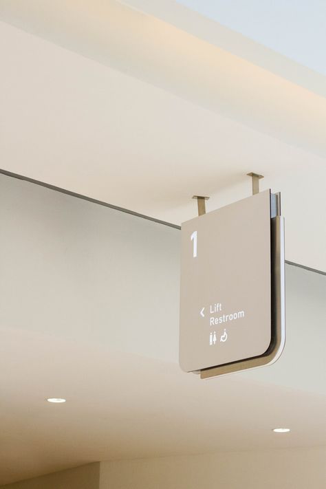 Amenity signage in matte white acrylic, featuring a brushed steel outline. Hospital Signage Design, Room Signage Design, Interior Signage Design, Signage System Design, Minimalist Signage, Office Signage Design, White Signage, Hospital Signage, Interior Signage