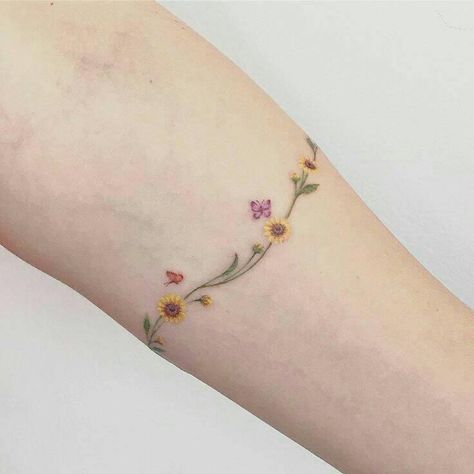 Daisy Chain Bracelet Tattoo, Daisy Bracelet Tattoo, Sunflower Ankle Tattoo Wrap Around, Daisy Chain Tattoo Ankle, Sunflower Vine Tattoo, Twist Tattoo, Daisy Chain Tattoo, Wrap Around Wrist Tattoos, Pug Tattoo