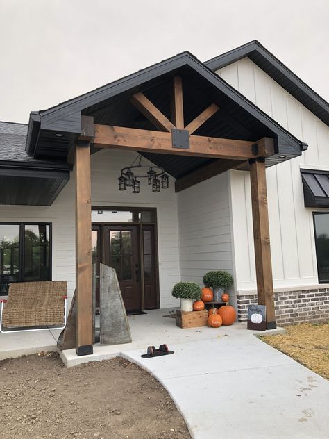 Covered Entryway Exterior Modern, Exterior Beams Front Porches, Porch Gables On House Exterior, Exterior Gable Ideas, Front Porch Gables, Wood Gables On House Exterior, Black White And Cedar Exterior, Dark House Exterior With Wood, Front Porch Gable Ideas