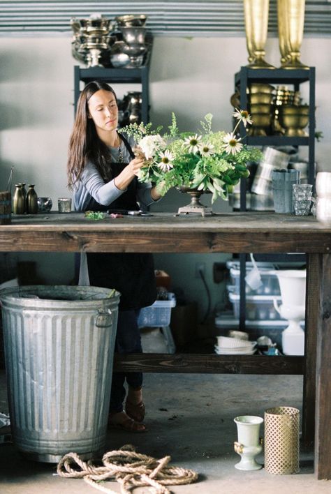 big, tall wood table with durable top, big garbage can, racks for hard goods...Honey of a Thousand Flowers // Sarah Winward Florist Table Work, Vase Storage Ideas, Floral Studio Work Spaces, Florist Studio Workspace, Florist Table, Shop Interiors Boutique, Vase Storage, Metal Backsplash, Sarah Winward