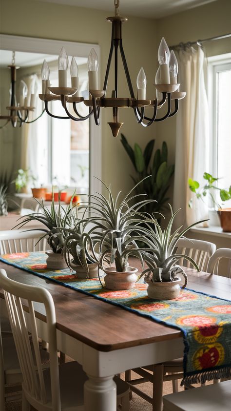 Discover how to create a warm and welcoming dining area featuring stylish air plants! Our centerpiece showcases elegant air plants in chic ceramic pots atop a sturdy INGATORP dining table, paired with classic NORDMYRA chairs. The vibrant SOMMAR 2023 table runner adds a pop of color, while a statement chandelier illuminates the space beautifully. Perfect for hosting friends or enjoying family meals, this setup combines functionality with aesthetic appeal. Ready to transform your dining experience? Click through for more inspiration! #IKEAStyle #AirPlants #HomeDecor #DiningRoomInspo #TableStyling #InteriorDesign #PlantLovers Ikea Style, Statement Chandelier, Hosting Friends, Statement Chandeliers, Ceramic Pots, Delicious Meals, Dining Space, Dining Experience, Air Plants