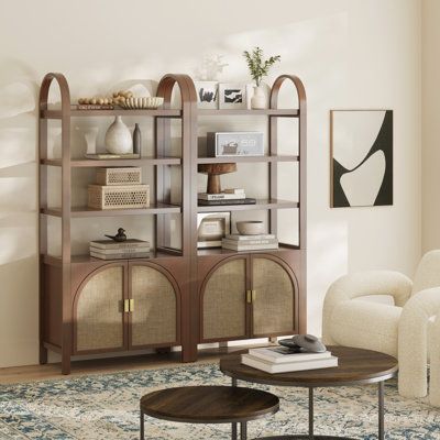 Here comes your new favorite bookshelf, the boho bookshelf cabinet! A true statement piece, this 3-tier bookshelf with cabinet base features a stunning deep and rich finish for an elegant vibe that will match your room - whether modern, rustic, or somewhere in between. The frame is crafted from solid wood to make sure it's stable and durable, while the shelves are made from high quality MDF with wood veneer, allowing it to carry up to 30 lbs of weight each to accommodate your favorite books and collectibles. And the best part - the faux rattan door details that add a charming boho touch, making it an eye catching accent piece in any room. Inside you'll find a spacious storage with adjustable interior shelves for hiding away your board games, electronics, or random cables. Color: Brown/Beig Bookshelf With Cabinet Base, Arched Cabinet Doors, Boho Bookshelf, Bookshelf With Cabinet, Rattan Bookshelf, Home Office Dark, Rattan Door, Bookshelf Table, Rattan Doors