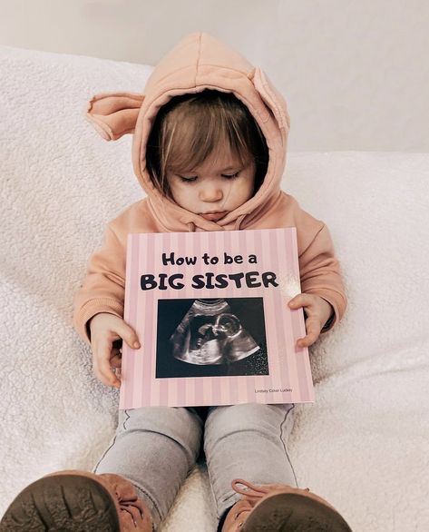 The cutest way to annoumce a second pregnancy with this adorable prop ‘How To Be A Big Sister’ Book! #ultrasound #bigsister #pregnancyannouncementideas #pregnancyreveal #bigsibling How To Be A Big Sister Announcement, Big Sister Pregnancy Announcement, Sister Pregnancy Announcement, Pregnancy Announcement Big Sister, Sister Announcement, Big Sister Announcement, Outdoor Portrait Photography, Outdoor Portrait, Sisters Photoshoot