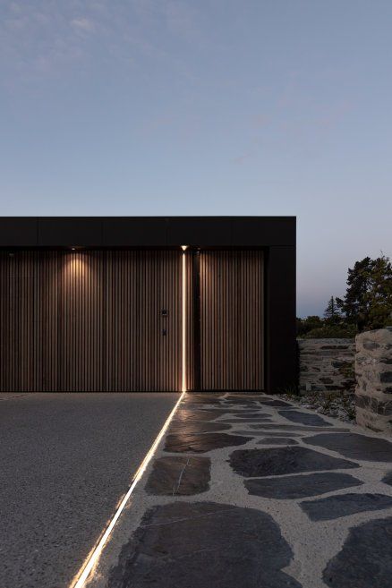 Lower Shotover House - Dravitzki Brown Architecture | ArchiPro Brown Architecture, Cedar Shutters, Modern Entrance Door, Entrance Lighting, Lake Wakatipu, Modern Garage, Facade Lighting, Built In Seating, Garage Lighting