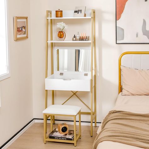 Price: $249.99
Color: White + Gold
Size: Small
Material: Engineered Wood, Metal
Dimensions: 39.5D x 60W x 164.5H cm
Features: Flip-up mirror, 2-tier shelves, 4 storage compartments, cushioned stool, anti-tipping device, compact design.
Brand: COSTWAY
Weight: 52.5 lbs
Assembly Required: Yes Vanity Next To Bed, Bedroom White Gold, Dressing Table For Small Space, Small Makeup Vanity, Small Spaces Bedroom, Small Makeup Vanities, Vanity Dressing Table, Makeup Dressing Table, Vanity Benches