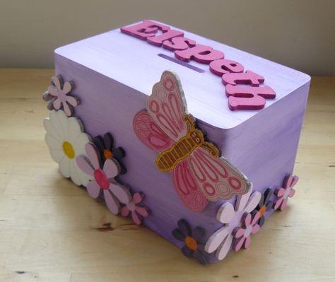 This wooden money box was painted lilac before being personalised with our 3cm wooden letters and then decorated with wooden daisies and an engraved wooden butterfly Mdf Letters, Letters Ideas, Wooden Butterfly, Bulk Buying, Wooden Money Boxes, Ply Wood, Money Box, Wooden Letters, Felt Fabric