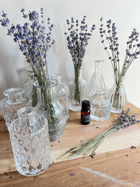 Lavender is well known to promote a sense of calm. We have created this all natural dried lavender aromatherapy diffuser to not only impart a beautiful smile into your home but to give a beautiful vintage inspired look.  A sweet posy of homegrown lavender a full size bottle of essential oil and vintage inspired bud vase is what you will get in this sweet little set.  We recommend starting with just a couple of drops of essential oil in the bottom of the vase. A little goes a long way. If you will be keeping this close to your bedside definitely start small however if you are trying to fill a room you may want to add a little more after you see how a couple drops does.  As with any essential oil please consult your doctor before exposing yourself to them. It's a good rule of thumb if you ar Lavender Plant Centerpieces, Lavender Vase Arrangement, Dried Lavender Bouquet In Vase, Dried Lavender Centerpiece Wedding, Dried Lavender Table Decor, Lavender Flower Decor, Dried Lavender Uses Decor, Dried Lavender In Vase, Dried Lavender Arrangements