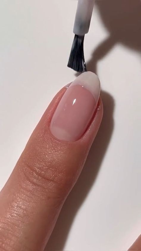 Elevate your style with a subtle yet sophisticated muted French nail design on almond-shaped nails. This timeless look is perfect for any occasion, exuding elegance and simplicity. Discover tips to create the perfect at-home French manicure. #NailPolishNaturalColors #AtHomeFrenchTipNails #GelFrenchManicureTutorial #FrenchNailShortNails #SimpleShortNailsNatural Nail Polish Natural Colors, Buffed Nails Natural, At Home French Tip Nails, Simple Short Nails Natural, Natural Gel Overlay, French Nail Short Nails, French Tips Real Nails, Natural Gel Manicure Design, Manicure Ideas For Short Nails Natural French Tips