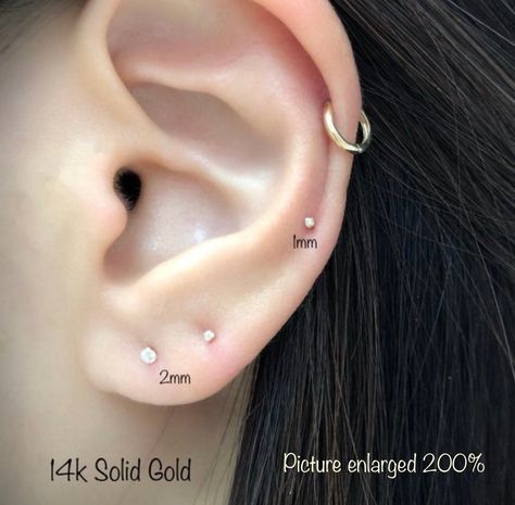 Sold as Pair   IMPORTANT!! Please note that the photo is an extreme close up, please double-check the measurements prior to purchasing. Super Tiny 14k Solid Gold CZ Stud Earrings (PAIR) * Earring post: 20g/0.8mm    * Earring Cubic Size: 2mm, 3mm, 4mm, 5mm and 6mm  * post length 8mm * Material: 14k SOLID GOLD, High Polished (Ok to shower, workout, washing, etc) * 14k solid gold Butterfly Backs Round MM size to round carat 2mm - 0.03ct 3mm - 0.11ct 4mm - 0.25ct 5mm - 0.50ct 6mm - 0.84ct 💥 *THIS I Diamond Nose Stud, Solid Gold Earrings, Tiny Studs, Tiny Earrings, Gold Stud Earrings, Cz Stud Earrings, Dainty Bracelets, Nose Stud, Gold Stud