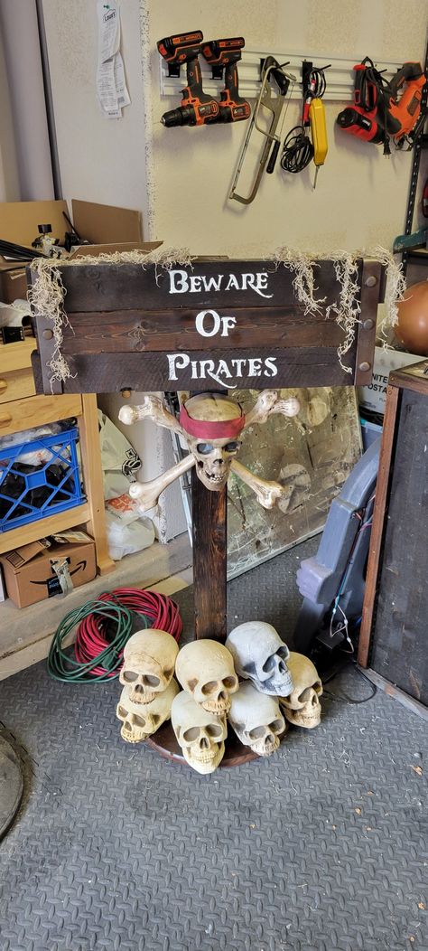 Sign I made using scrap pallet Wood and foam skulls. Skeleton Pirate Halloween Decorations, Midevil Halloween Decor, Pirate Party Ideas Decorating, Halloween On The Beach, Halloween Pirates Decorations, Pirate Haunted House Ideas, Pirates Halloween Decorations, Pirates Of The Caribbean Halloween Decor, Pirate Trunk Or Treat Ideas