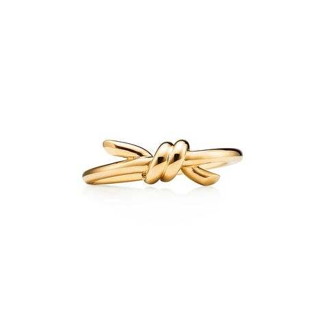 Tiffany Knot is an expression of love’s unwavering bonds. Inspired by an archival bow crafted in 1889, Knot is a symbol of life’s most enduring ties and meaningful connections. This ring is crafted with yellow gold and polished by hand for high shine. Wear on its own or partnered with classic silhouettes for an unexpected pairing. 18k yellow gold; Features Tiffany & Co. hallmark. | Tiffany Knot Ring in Yellow Gold, Size: 10 1/2 Tiffany Knot Ring, Tiffany Knot, Tiffany Rings, Rope Rings, Jewelry Knots, International Jewelry, Life Symbol, Knot Design, Knot Ring