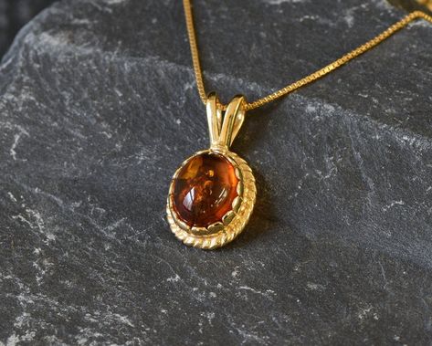 Gold Amber Pendant set with Natural Amber in the highest quality & brownish-yellow translucent resin, at 10x8mm, 3 Carats, sourced from Russia. Gold Dainty Pendant in Vintage design made of Gold Vermeil ☞ thickest 18k Gold Plating on top of Solid 925 Sterling Silver ☞ made to last. Free Gold Vermeil Chain with every Pendant order, 18 inch Silver chain (46 cm) ✓ Matching Ring & Earrings - please ask me ⌛Last Pendant left ⌛ ❀ Each Natural Gem is unique & will have Slight variations from the produc Faberge Jewelry, Amber Gemstone, Matching Ring, Amber Pendant, Dainty Pendant, Real Jewelry, Natural Amber, Vintage Pendant, Gold Stone