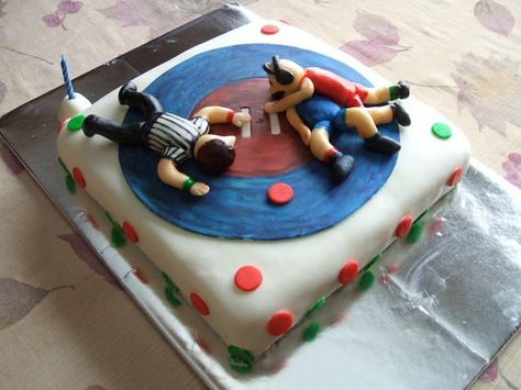 wrestling birthday cake - I made this cake for my son's 16th birthday. He is a wrestler, and a pretty good one! He was so happy showing off the cake to his friends. I used the  yellow DH cake, filled with rasberry jam. The BC I made irish cream flavored, and covered with satin ice. The wrestlers and ref are fondant. I know is not the best work, but it was my first, and I had so much fun creating this cake!!!  I'm very happy with the result, and so is my son. Wrestling Birthday Cakes, Wrestling Cake, Wrestling Birthday, Bad Cakes, Portable Dessert, Best Birthday Cake, Birthday Cake Cake, Batman Birthday, Candy Cakes