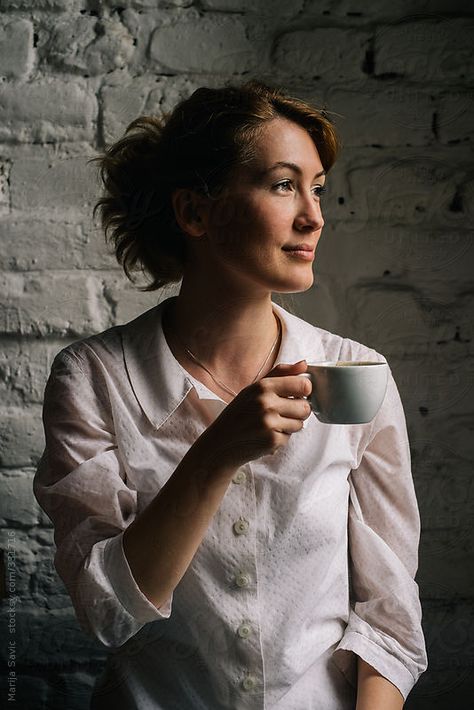 Woman Holding a Cup of Coffee  by Marija Savic for Stocksy United Holding Tea Cup Pose, Hand Holding Tea Cup Reference, Coffee Holding Pose, Woman Holding Coffee Cup, Person Holding Teacup Reference, Holding A Coffee Cup Pose, Sipping Tea Pose Reference, Holding Mug Pose Reference, Holding Coffee Pose Reference