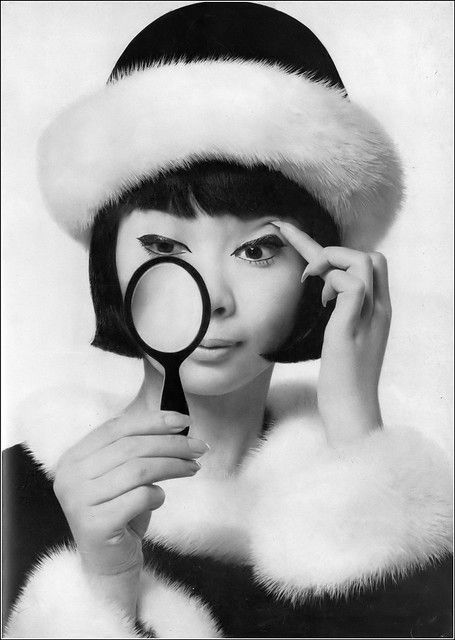 Hiroko is wearing a black velvet roller with a white mink brim by Jean Barthet, tweed suit trimmed in white mink by Maggy Rouff, photo by Richard Avedon, Harper's Bazaar, September 1961 Richard Avedon Photography, Maggy Rouff, Goth Glam, Tweed Suit, Richard Avedon, Black Mascara, Tweed Suits, Film Producer, 1960s Fashion