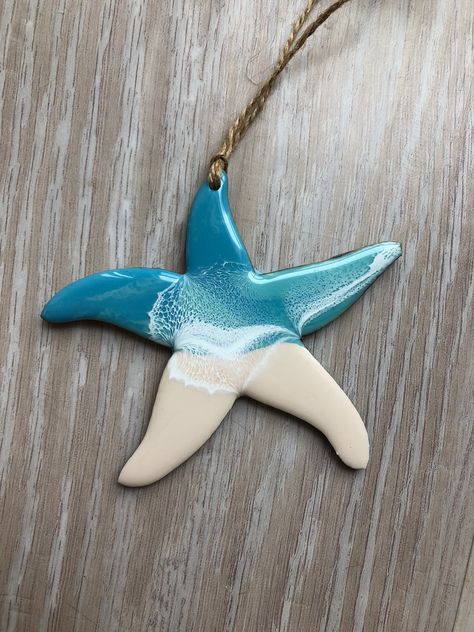 This listing is for 1 resin and wood starfish ornament. Perfect for decorating your Christmas tree or even as a year round decoration. Ornaments are 4 inches and hang from a natural jute twine. The back of the ornament is painted blue. Please refer to the number at the bottom of each picture when ordering. The ornament pictured is the ornament you will receive. Fishing Christmas Ornaments, Sand Dollar Ornament, Starfish Art, Christmas Palm Tree, Beach Christmas Ornaments, Coastal Ornament, Round Decoration, Pottery Ornaments, Beach Ornaments