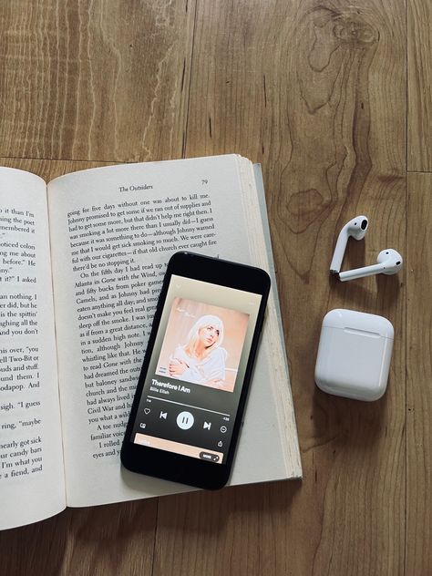 iPhone connected to AirPods playing Billie Eilish, therefore I am. Dark aesthetic and a paper back book behind the music Books Aesthetic With Airpods, Airpods And Books Aesthetic, Airpods Music Aesthetic, Book And Music Aesthetic, Reading And Music Aesthetic, Music And Books Aesthetic, Audio Book Aesthetic, Books And Music Aesthetic, Snp Idea