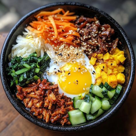 Bibimbap originated from Korean royal cuisine but quickly became a beloved dish for the masses. Traditionally, it was a way to use leftover vegetables and rice, with everything mixed together for a colorful, flavorful meal. Its vibrant presentation symbolizes harmony and balance, two important principles in Korean culture.

#Bibimbap #KoreanFood #HealthyMeals #Gochujang #AsianCuisine #RiceBow Korean Mixed Rice, Bimbimbop Bowl, Bibimpab Korean, Bibimbap Aesthetic, Chicken Bibimbap, Traditional Korean Food, Uni Meals, Korean Bowl, Korean Rice Bowl