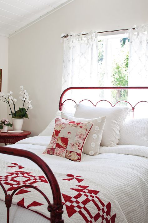 white bedroom with red metal bed frame and quilt at the foot of the bed California Cottage, Cottage Journal, Red And White Quilts, Red Cottage, White Interior Design, Cottage Charm, Red Bedding, Cottage Bedroom, Bedroom Red