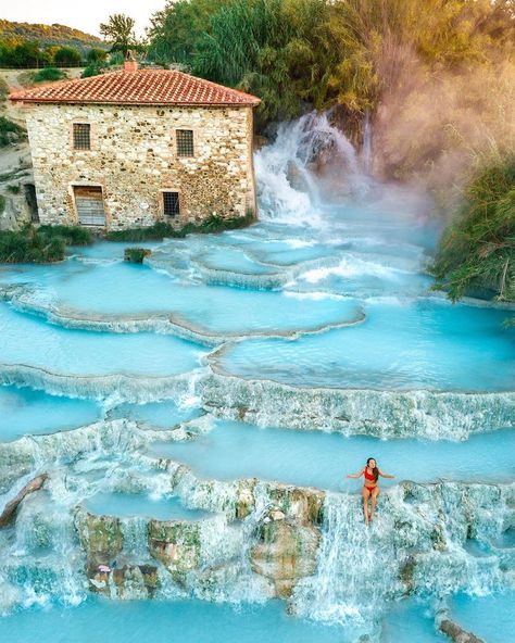 Saturnia, Italy 🇮🇹 The image showcases the mesmerizing natural hot springs of Saturnia, located in the Tuscany region of Italy. The Terme di Saturnia, with its cascading pools of warm, mineral-rich water, offer a truly unique and rejuvenating experience. Surrounded by lush greenery and the rustic charm of the ancient stone mill, this thermal oasis is a hidden gem in the Italian countryside. The soothing waters, naturally heated by the earth, have been attracting visitors for centuries, makin... Saturnia Italy, Natural Hot Springs, Ancient Stone, Italian Countryside, Regions Of Italy, Water Sources, Lush Greenery, Hidden Gem, Hot Springs