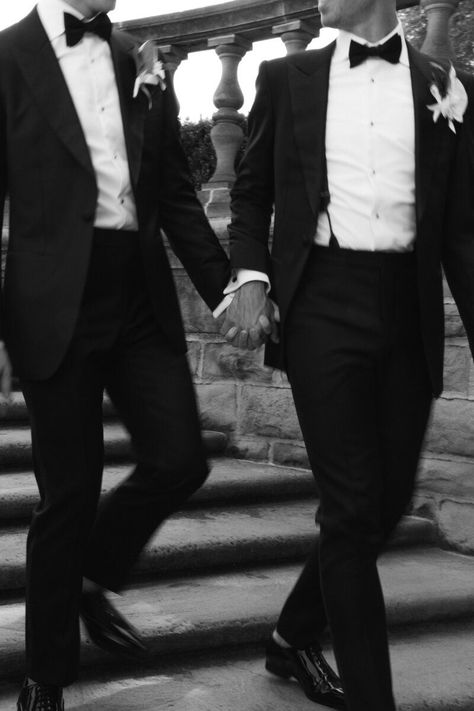 motion photo of gay couple in tuxes walking down stairs hand in hand Wedding Tux Aesthetic, Gay Couple Wedding Photo Ideas, Queer Wedding Photos, Mlm Wedding, Gay Wedding Suits, Gay Wedding Aesthetic, Wedding Party Aesthetic, Gay Engagement Photos, Gay Wedding Ideas