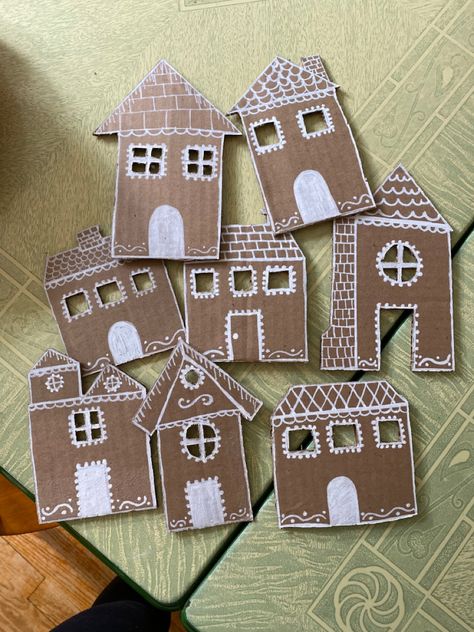 Homemade cardboard gingerbread houses that will be made into a garland! Cardboard Gingerbread House Garland Diy, Gingerbread Houses Cardboard, Cardboard Gingerbread House Garland, Diy Cardboard Christmas Crafts, Gingerbread Cardboard House, Cardboard Gingerbread House Diy, Cardboard Garland, Gingerbread House Cardboard, Cardboard Gingerbread Houses