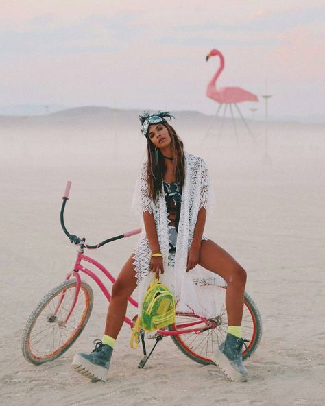 Rocking a mix of boho and neon, this look features a lace kimono, bold goggles, and platform boots. The pink bike and giant flamingo add playful festival vibes 🌈🦩 @laurakubrusly 🔥🔥 Burning Girl, City Festival, Festival Outfit Inspiration, Pink Bike, Black Rock City, Rock City, Burning Man Festival, Bicycle Women, Lace Kimono